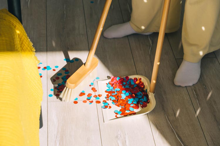 Någon sopar upp konfetti efter ett event kvällen innan